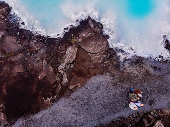 Aerial view of friends standing at blue lagoon