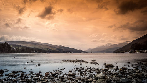 Scenic view of lake against sky during sunset