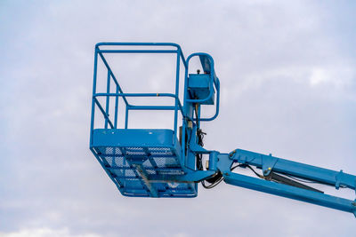 Low angle view of crane against sky