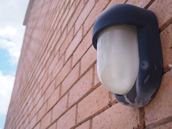 Low angle view of electric lamp on wall