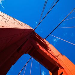 Low angle view of cables against blue sky