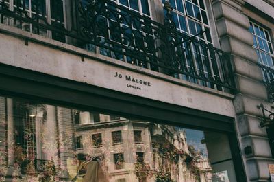 Low angle view of building seen through glass window