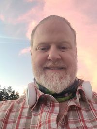 Portrait of man smiling against sky