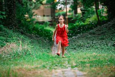 Full length of woman running on grass