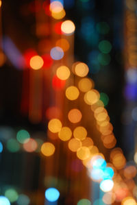 Defocused image of illuminated christmas lights at night