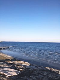 Scenic view of sea against clear blue sky