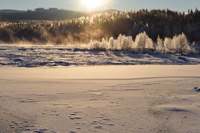 Scenic view of beach against sky during winter