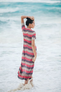 Young woman standing at beach