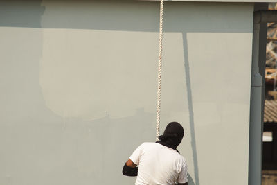 Rear view of man standing on terrace