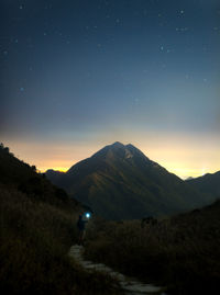 Scenic view of mountains against sky at night