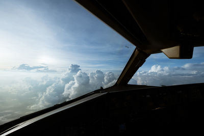 Low angle view of sky seen through car window