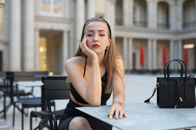 Young woman using mobile phone in cafe