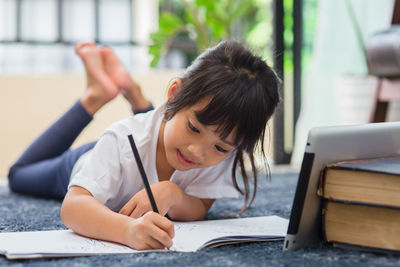 Portrait of girl sitting on table