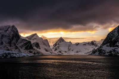 Scenic view of snowcapped mountains against sky during sunset