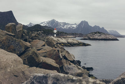 Scenic view of rocks in sea against sky