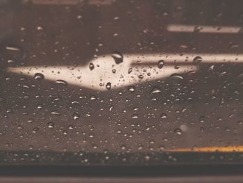 Full frame shot of raindrops on window