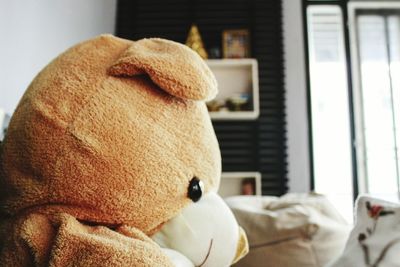 Close-up of teddy bear on bed at home