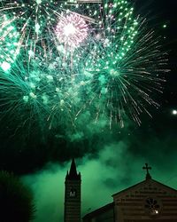 Low angle view of firework display at night