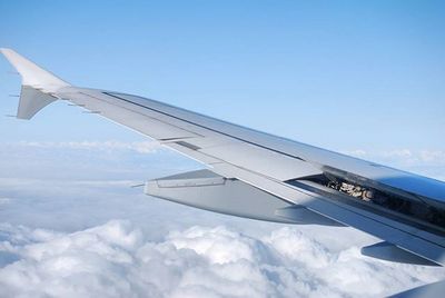 Close-up of cropped airplane against blue sky