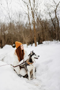 Dog standing on snow covered field