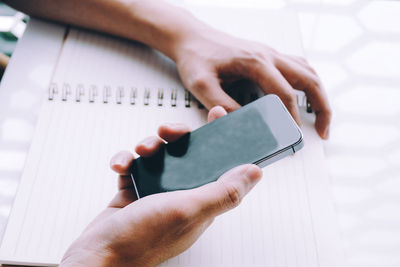 Close-up of man holding mobile phone