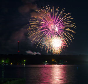 Low angle view of firework display at night