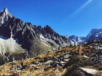 Scenic view of snowcapped mountains against clear blue sky