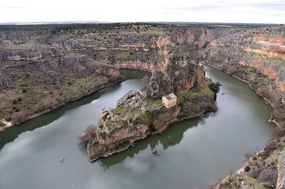 High angle view of rock by river against sky