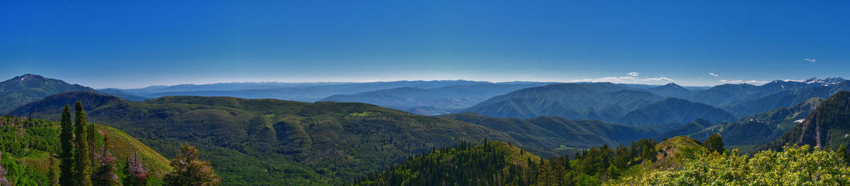 Scenic view of mountains against clear blue sky