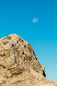 Low angle view of rock formation against sky