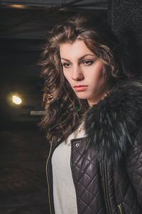 Beautiful woman standing against column in parking garage