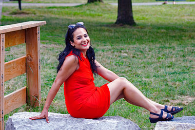 Portrait of smiling young woman sitting outdoors