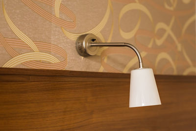 Close-up of electric lamp on table