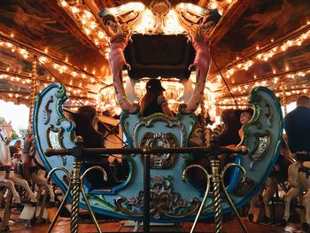 Low angle view of illuminated carousel at amusement park