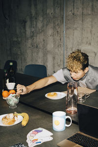 Man eating candy at table in office