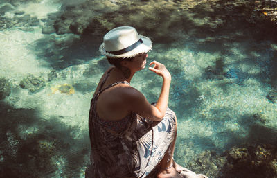 Full length of young woman in natural pool