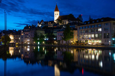 Reflection of buildings in city at night