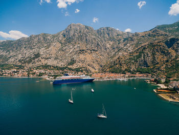 Sailboats in sea against sky