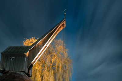 Low angle view of traditional building against sky at dusk