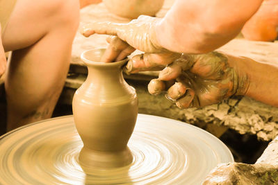 Cropped hands molding pot in workshop