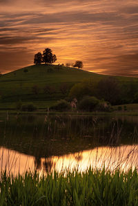 Scenic view of field against sky during sunset