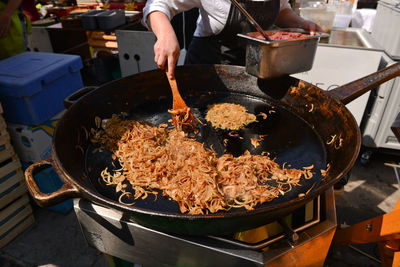 Close-up of fried onions on cooking pan