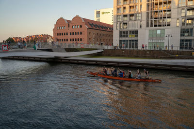 Boats in canal amidst buildings in city