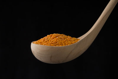 Close-up of bread in plate against black background