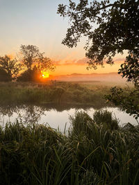 Scenic view of lake against sky during sunset