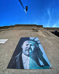 Low angle view of statue against blue sky