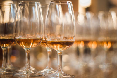 Close-up of wine glasses on table