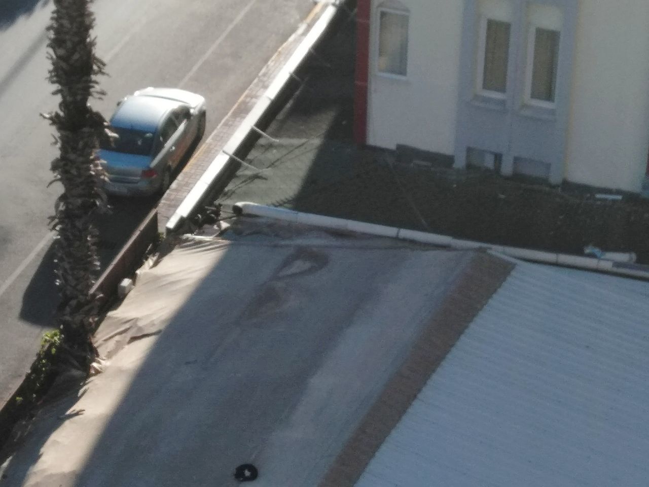 HIGH ANGLE VIEW OF STREET BY BUILDINGS IN CITY