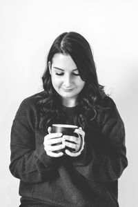 Young woman holding coffee cup