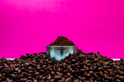 Close-up of coffee beans against pink background